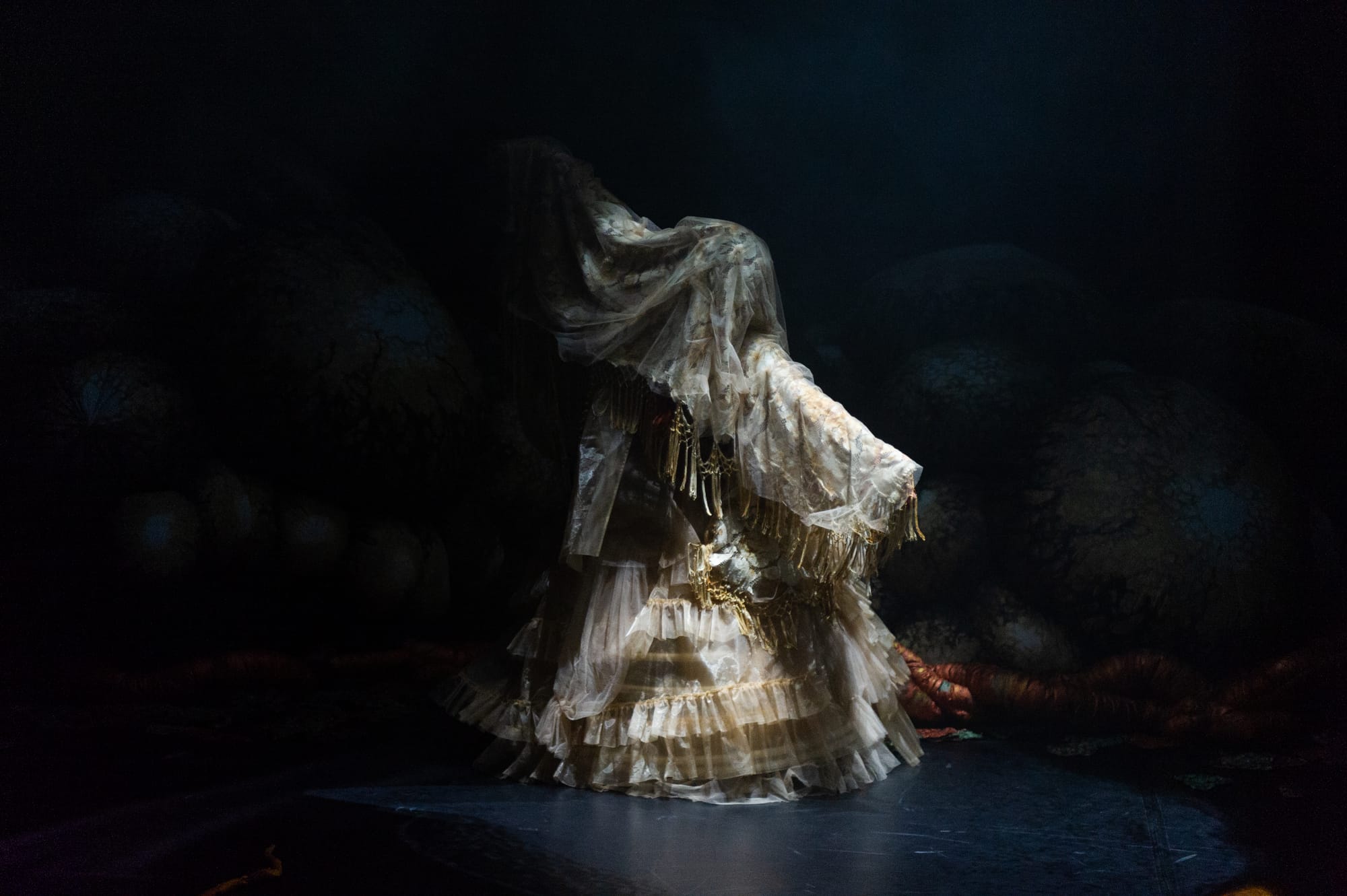 "The Figment" – an unearthly apparition that vaguely resembles a tassled wedding dress – is illuminated adopting an evocative pose against the darkness.